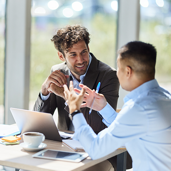 Two businessmen talking during a meeting